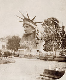 https://upload.wikimedia.org/wikipedia/commons/thumb/5/57/Head_of_the_Statue_of_Liberty_on_display_in_a_park_in_Paris.jpg/220px-Head_of_the_Statue_of_Liberty_on_display_in_a_park_in_Paris.jpg